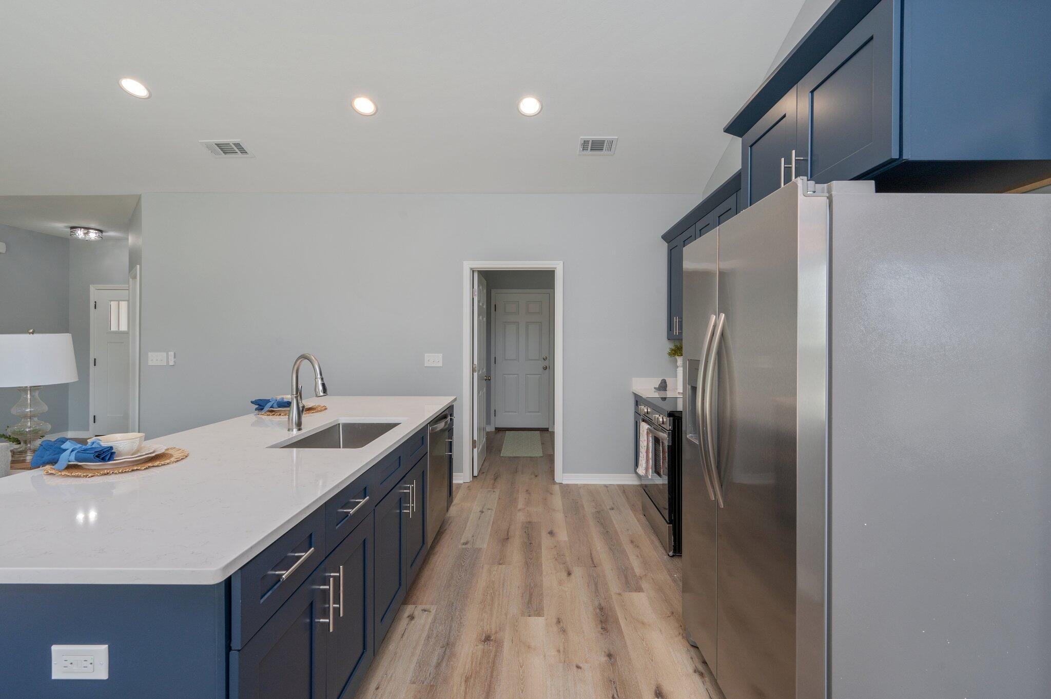 6010 Sand Hill Road Crestview, FL 32539 - Photo 11 of 33 a kitchen with kitchen island a sink stove and refrigerator