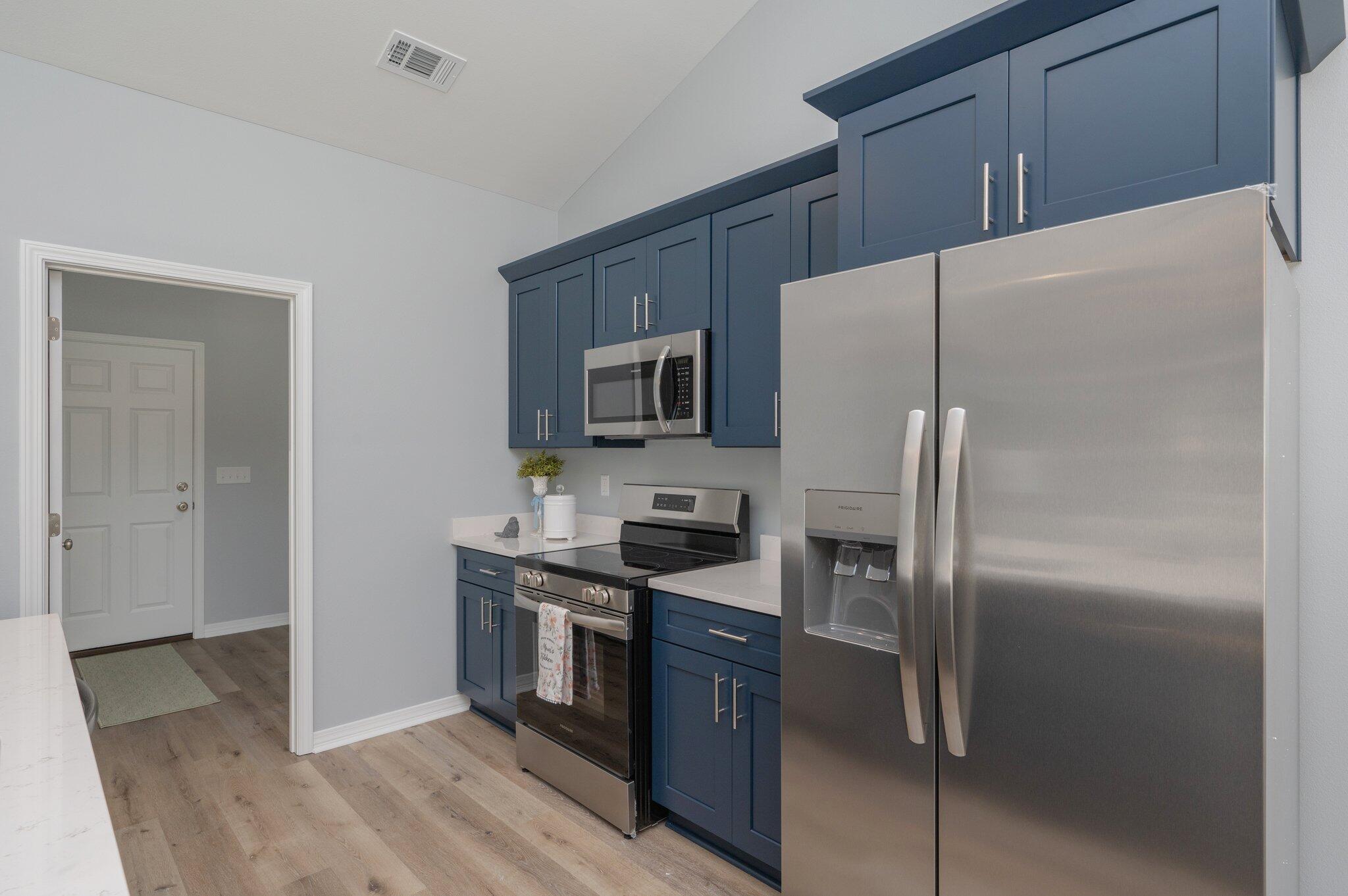 6010 Sand Hill Road Crestview, FL 32539 - Photo 13 of 33 a kitchen with stainless steel appliances granite countertop a refrigerator and a stove top oven