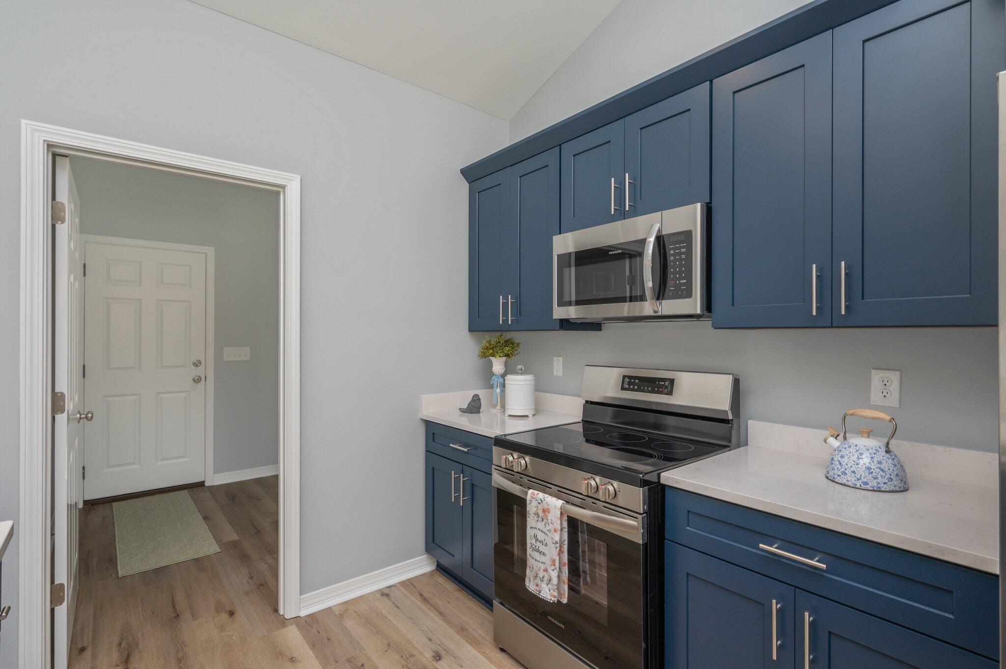 6010 Sand Hill Road Crestview, FL 32539 - Photo 14 of 33 a kitchen with stainless steel appliances granite countertop a stove a microwave and a sink