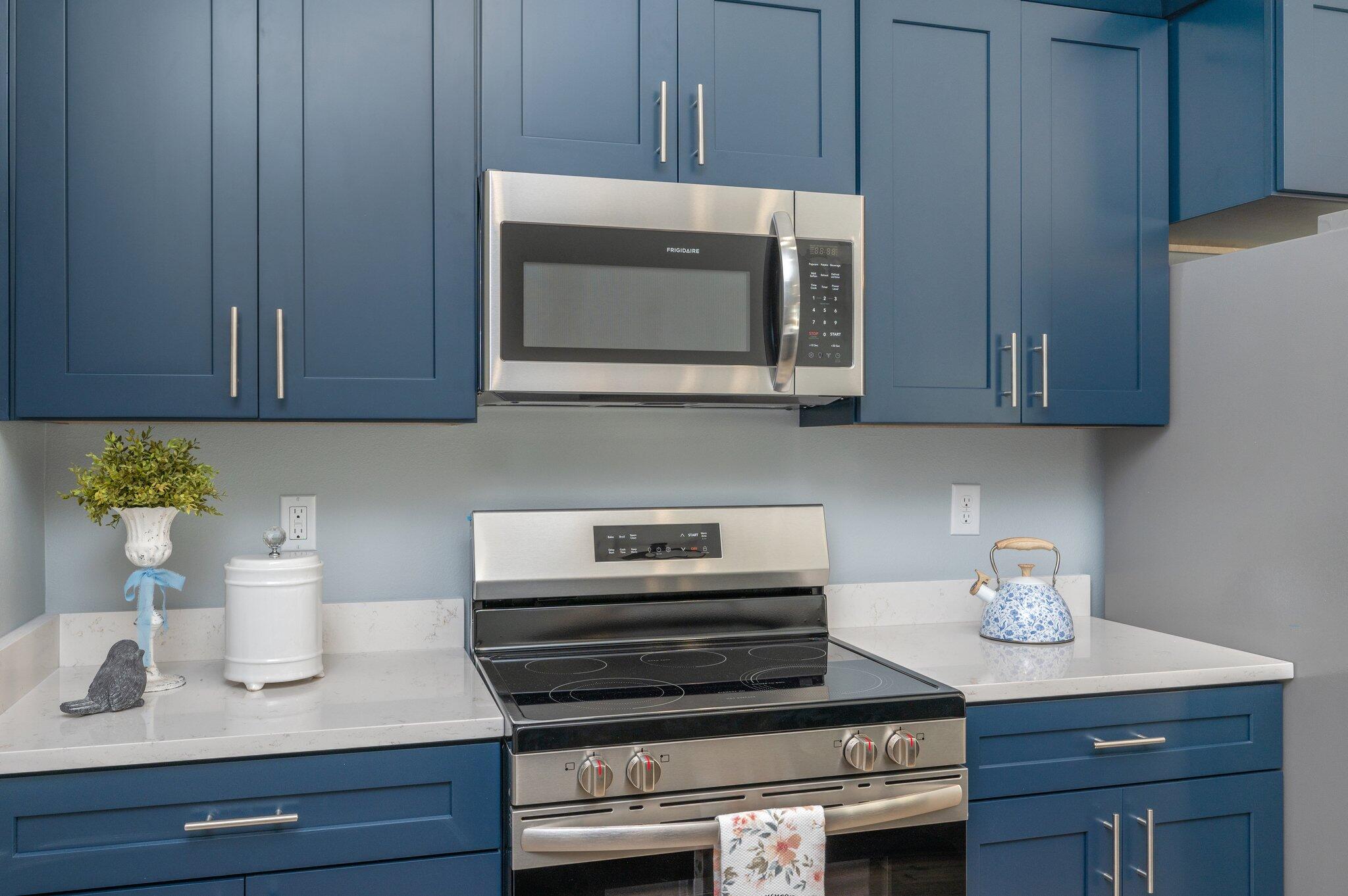 6010 Sand Hill Road Crestview, FL 32539 - Photo 15 of 33 a kitchen with a stove microwave and cabinets