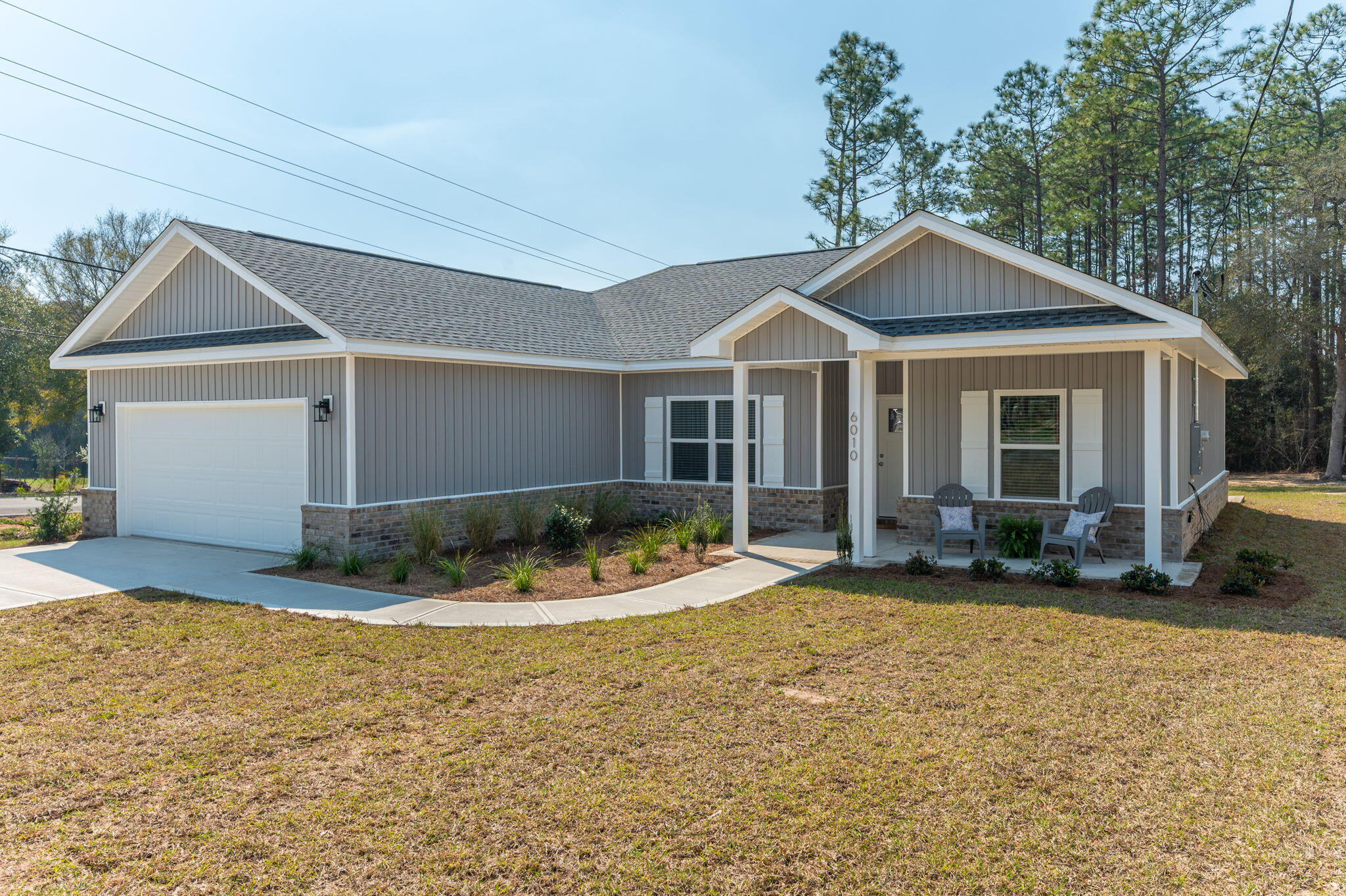 6010 Sand Hill Road Crestview, FL 32539 - Photo 2 of 33 a front view of a house with yard and porch