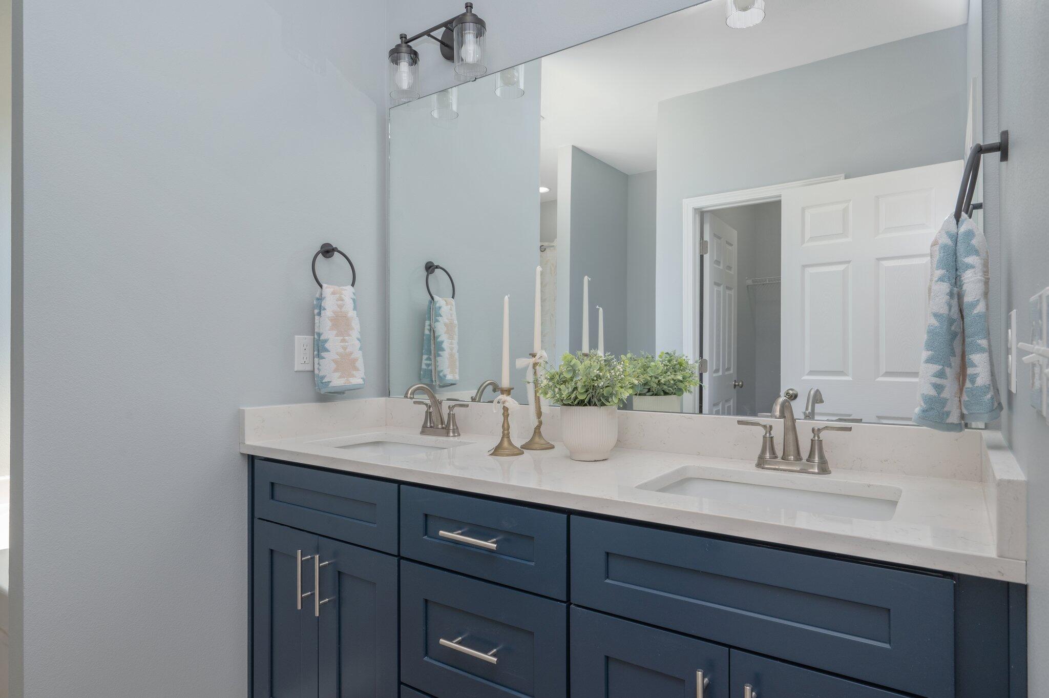 6010 Sand Hill Road Crestview, FL 32539 - Photo 21 of 33 a bathroom with double vanity sinks and a mirror