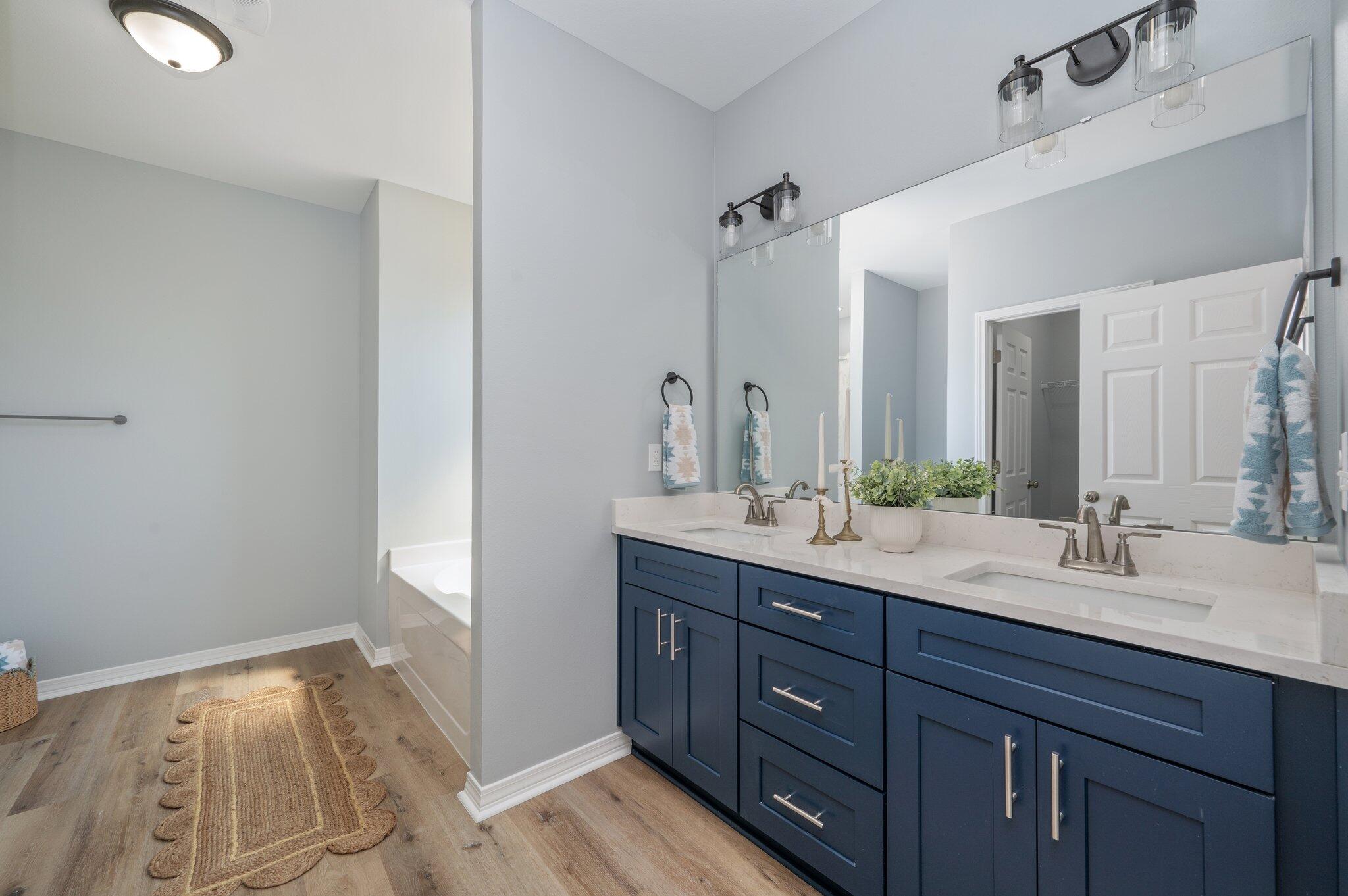 6010 Sand Hill Road Crestview, FL 32539 - Photo 23 of 33 a spacious bathroom with a double vanity sink and a mirror