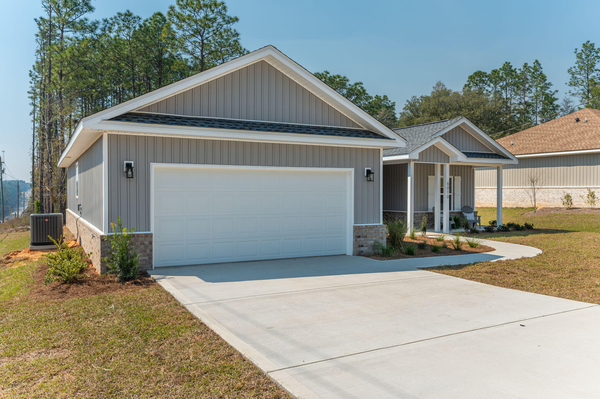 6010 Sand Hill Road Crestview, FL 32539 - Photo 3 of 33 a front view of a house with a yard and garage
