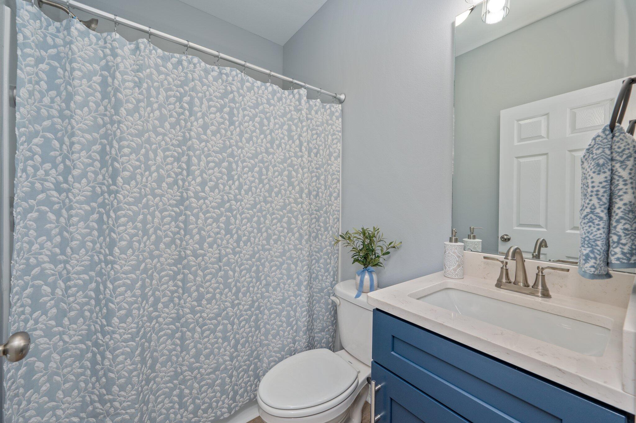 6010 Sand Hill Road Crestview, FL 32539 - Photo 33 of 33 a bathroom with a granite countertop toilet sink and mirror