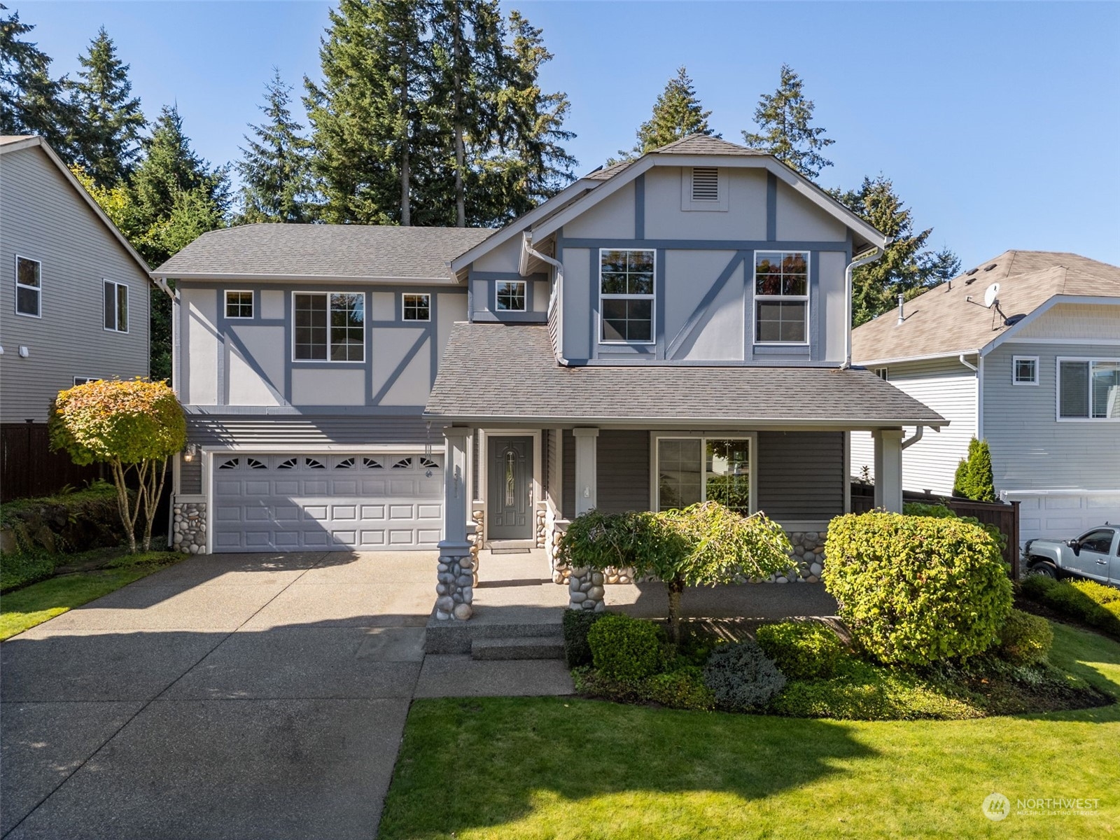1311 Foreman Road DuPont, WA 98327 - Photo 1 of 1 a front view of a house with a yard and a garden
