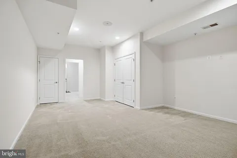 a view of an empty room with windows