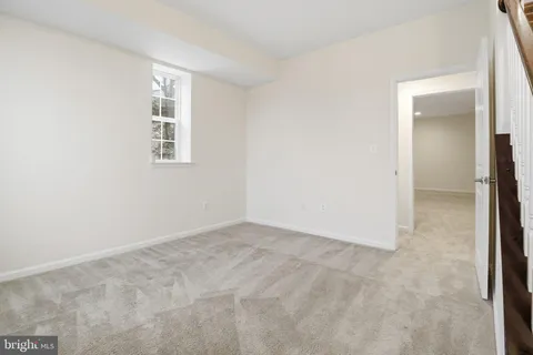 a car parked in front of a white house