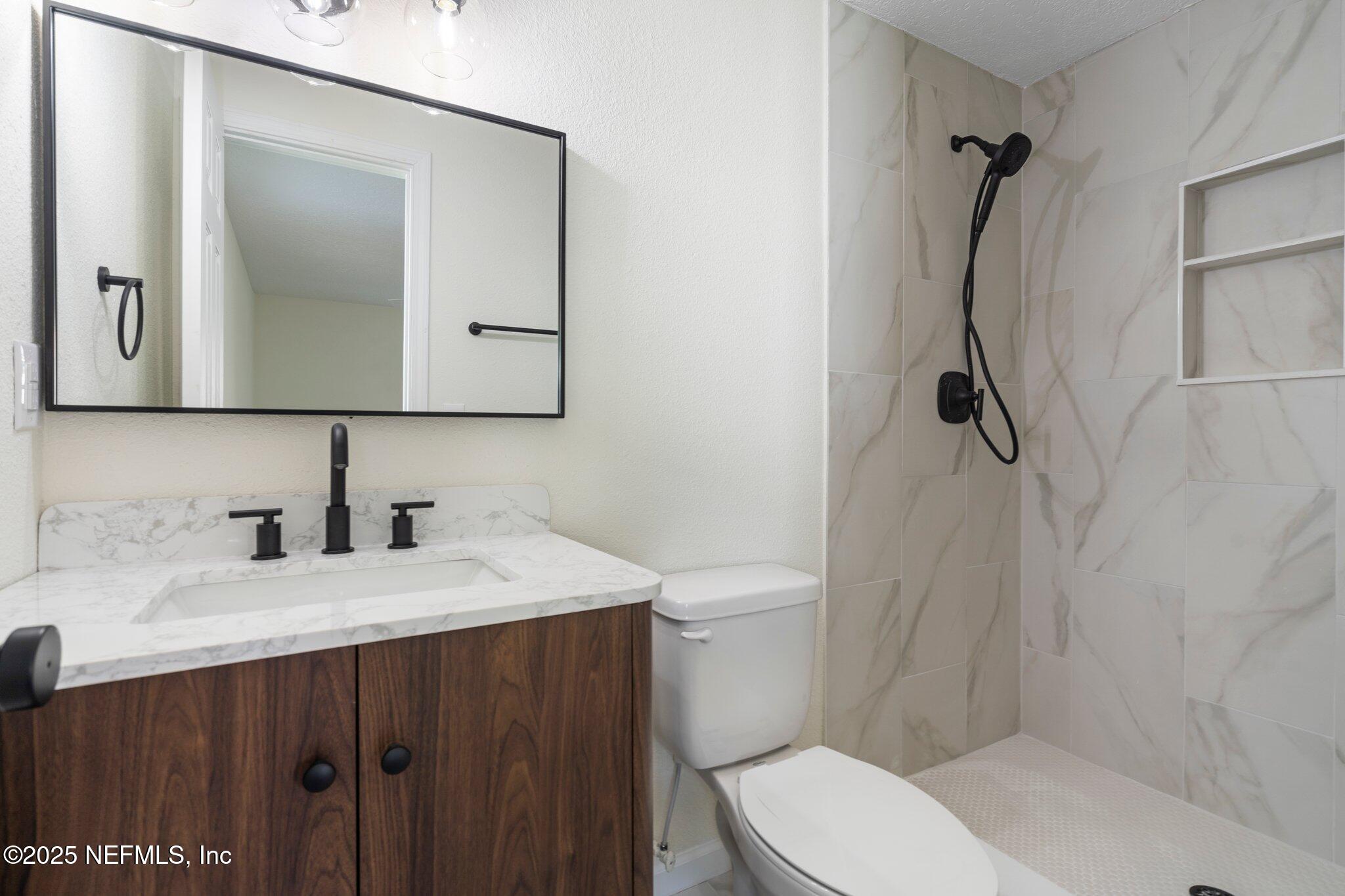 560 Aquarius Concourse Orange Park, FL 32073 - Photo 19 of 32 a bathroom with a sink vanity mirror and toilet