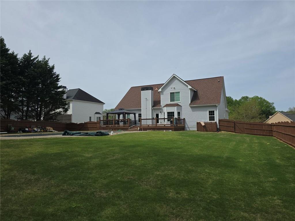 7125 Creek Ridge Drive Gainesville, GA 30506 - Photo 2 of 4 a front view of house with yard barbeque and outdoor seating