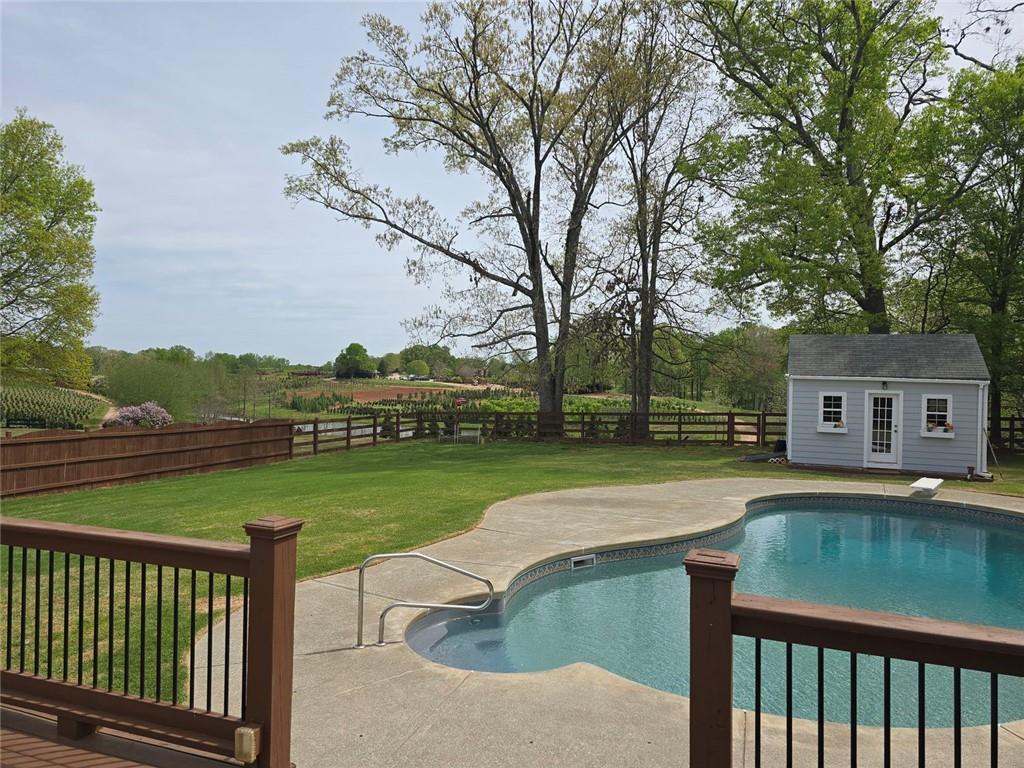 7125 Creek Ridge Drive Gainesville, GA 30506 - Photo 4 of 4 a view of a patio with a table chairs and a yard