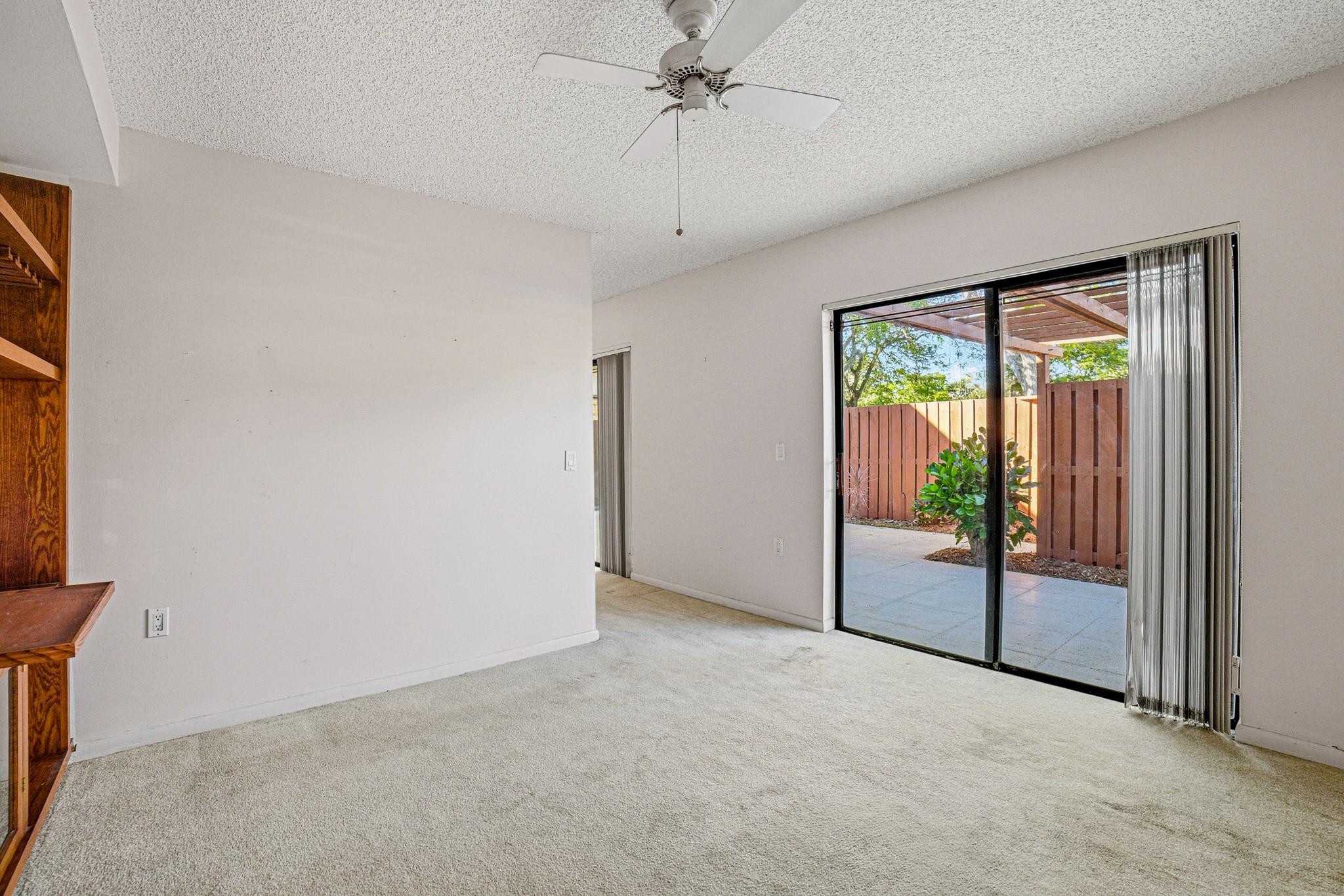 9101 Southwest 19th Place, Unit B Davie, FL 33324 - Photo 18 of 55 an empty room with sliding door