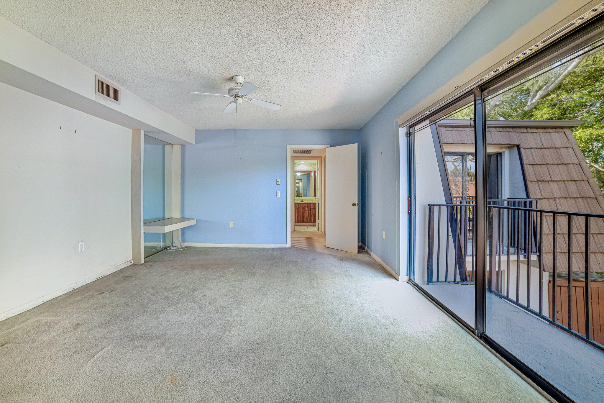 9101 Southwest 19th Place, Unit B Davie, FL 33324 - Photo 19 of 55 an empty room with windows & wooden door