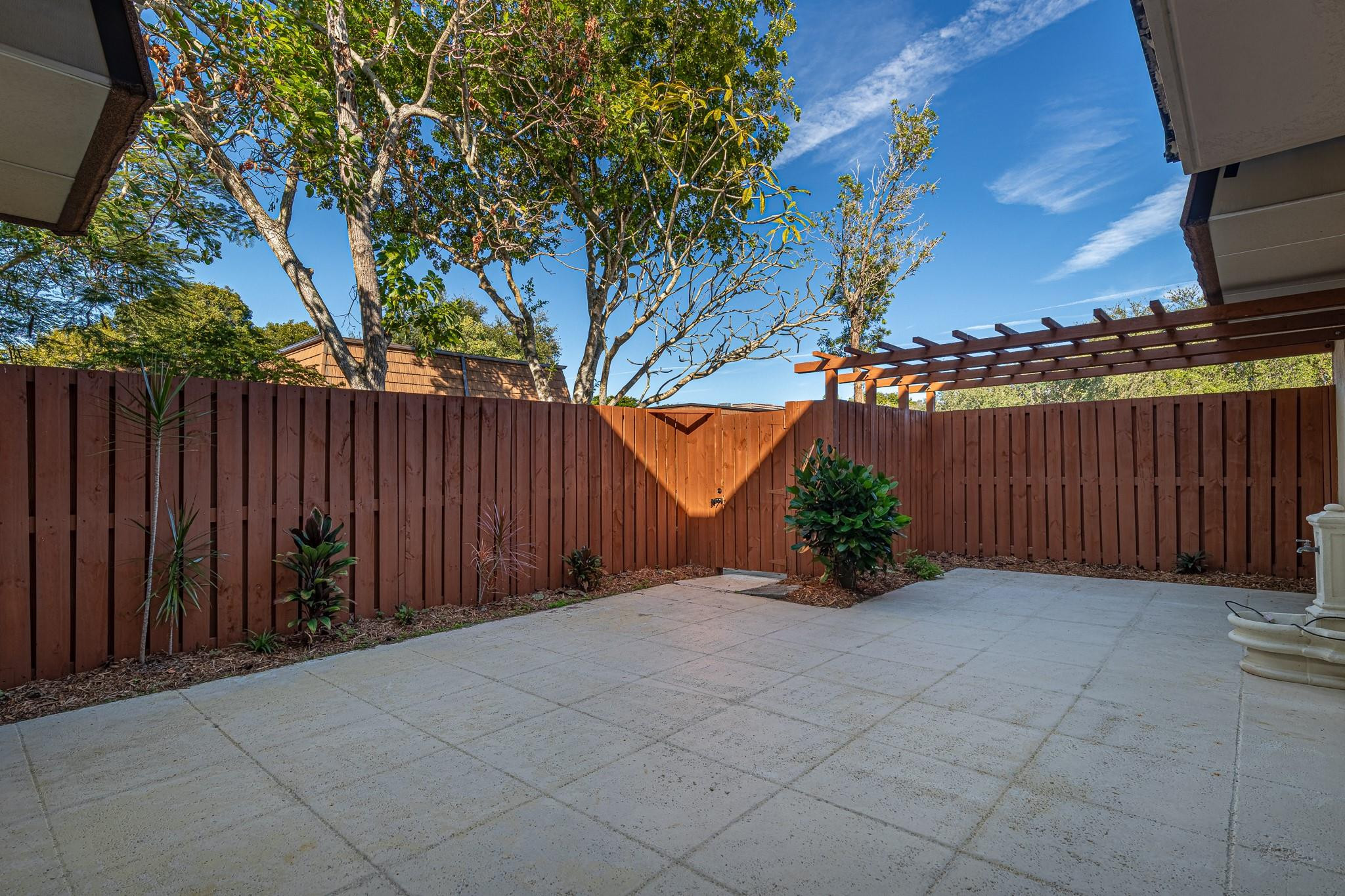 9101 Southwest 19th Place, Unit B Davie, FL 33324 - Photo 33 of 55 a view of backyard with potted plants and a large tree