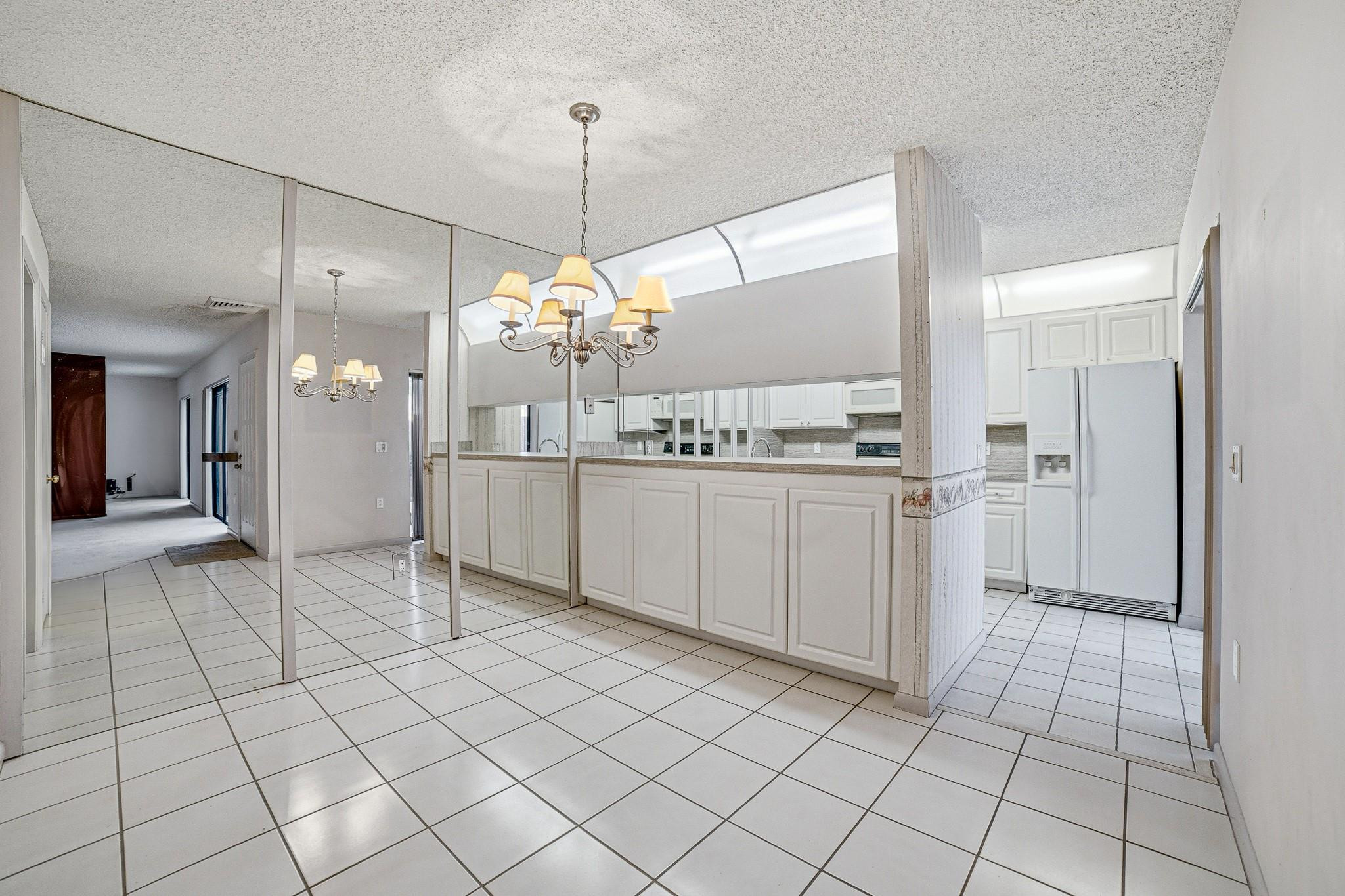 9101 Southwest 19th Place, Unit B Davie, FL 33324 - Photo 5 of 55 a kitchen with stainless steel appliances kitchen island granite countertop a sink and cabinets