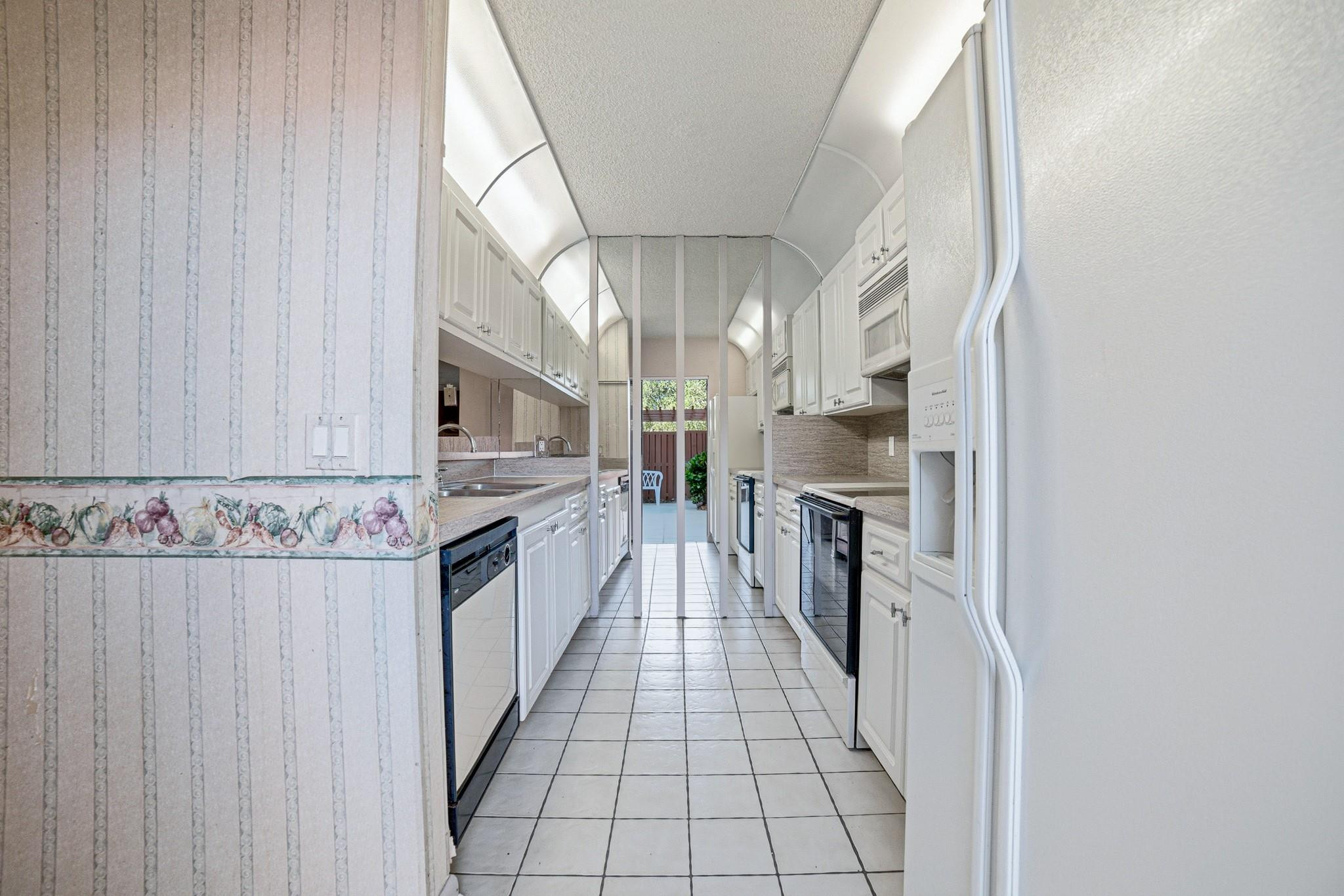 9101 Southwest 19th Place, Unit B Davie, FL 33324 - Photo 6 of 55 a kitchen with stainless steel appliances granite countertop a stove and a refrigerator