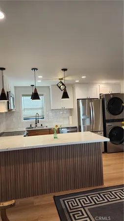 a kitchen with a sink and a stove top oven