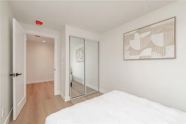 a room with a bed and a painting on the wall