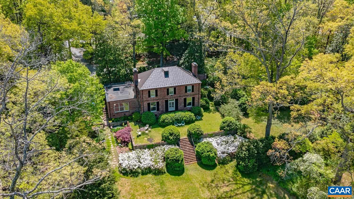 401-403 Georgetown Road Charlottesville, VA 22901 - Photo 5 of 56 a front view of a house with a yard and fountain