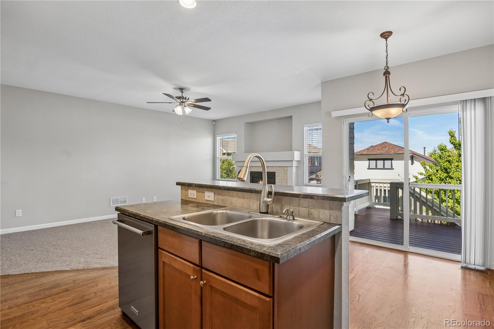 5031 South Rome Street Aurora, CO 80015 - Photo 10 of 39 a kitchen with a center island a counter space dining table and cabinetry