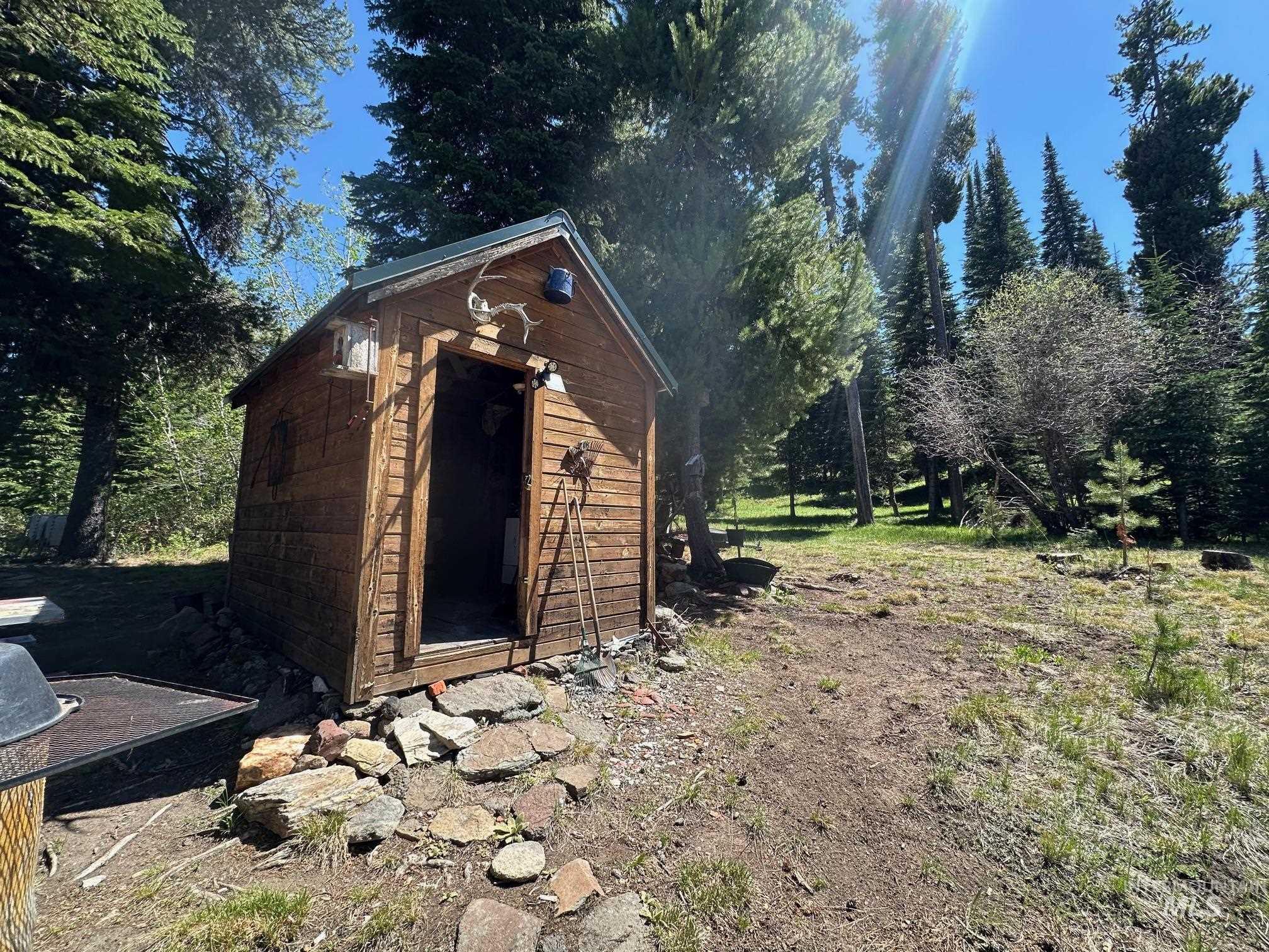 509 Deadline Road, Unit 2 Twin Falls, ID 83301 - Photo 3 of 28 Rustic cabin structure featuring wood siding, a metal roof, and an open entryway