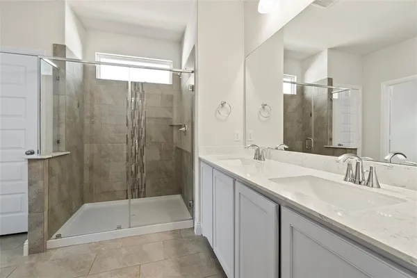 a bathroom with a shower and a sink