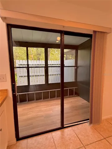 a view of a livingroom with wooden floor and window