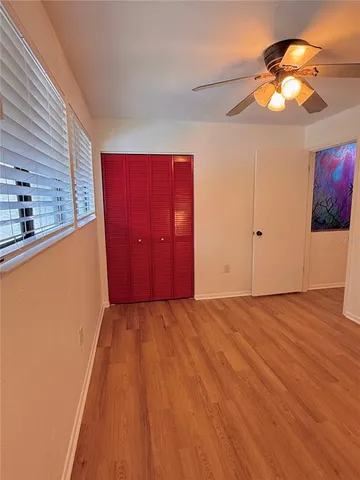 a bathroom with a granite countertop toilet a sink a mirror and shower curtain