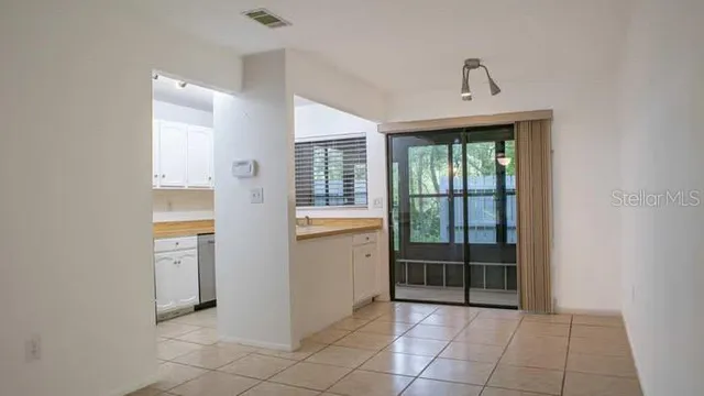 a kitchen with granite countertop a sink stove and cabinets