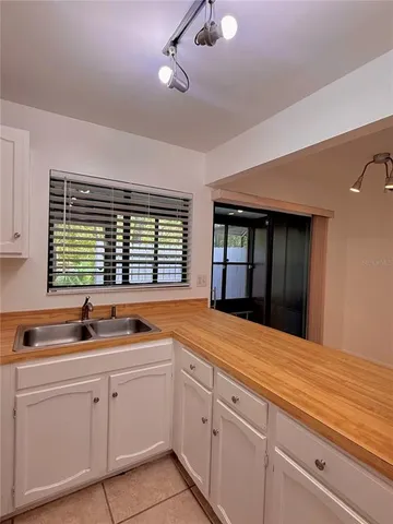 a kitchen with stainless steel appliances kitchen island granite countertop a refrigerator and a stove top oven