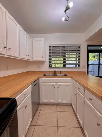 a kitchen with cabinets and stainless steel appliances