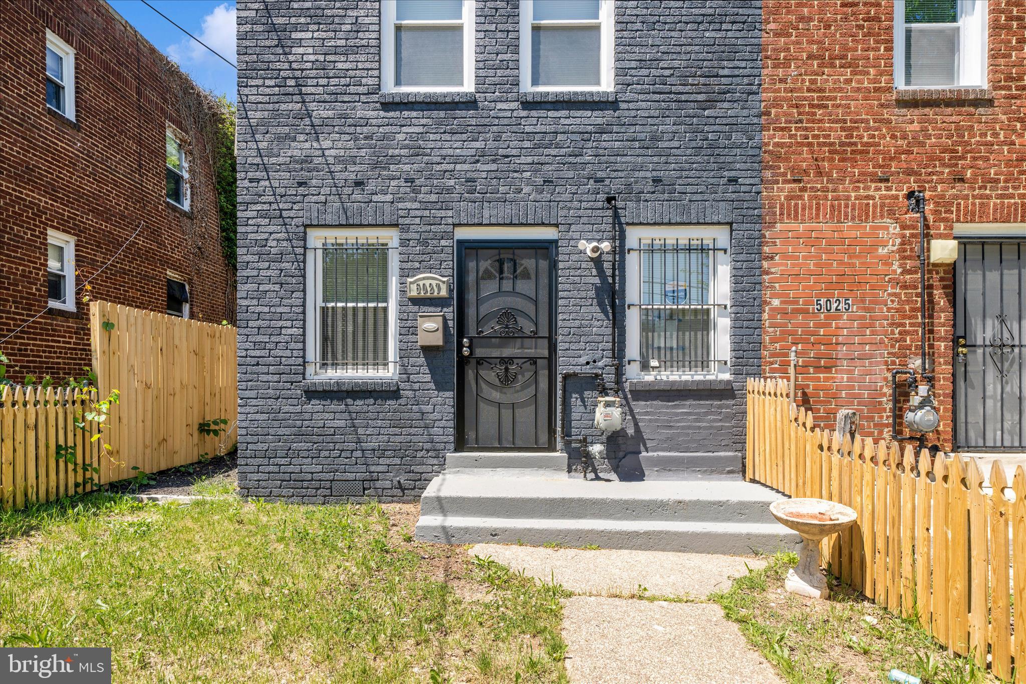 5027 Benning Road Southeast Washington, DC 20019 - Photo 2 of 57 a front view of a house with a garden