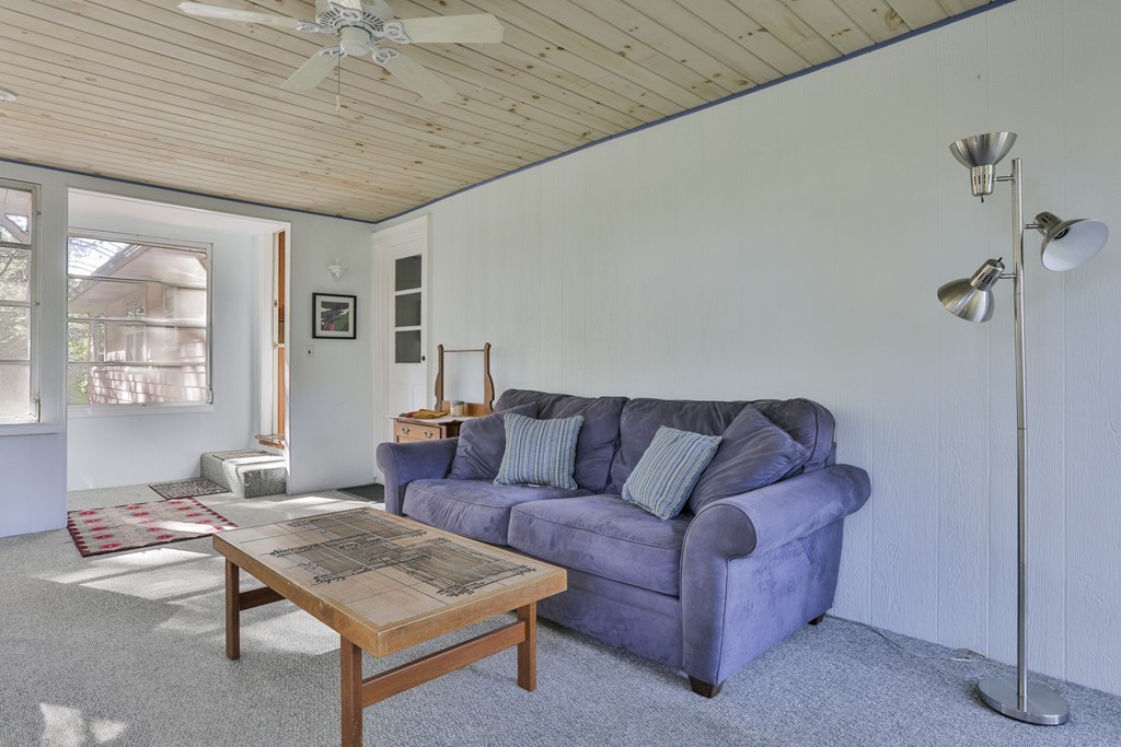 27 Gleason Road Reading, MA 01867 - Photo 21 of 28 a living room with furniture and a table