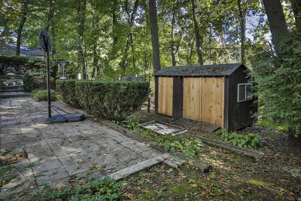 27 Gleason Road Reading, MA 01867 - Photo 28 of 28 a house is sitting in middle of forest