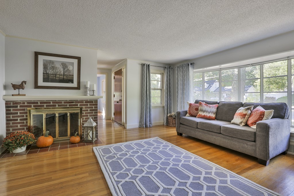 27 Gleason Road Reading, MA 01867 - Photo 5 of 28 a living room with furniture and a fireplace