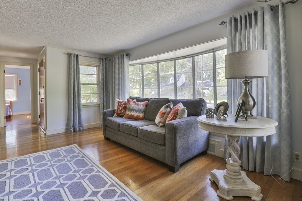 27 Gleason Road Reading, MA 01867 - Photo 6 of 28 a living room with furniture a lamp and a table