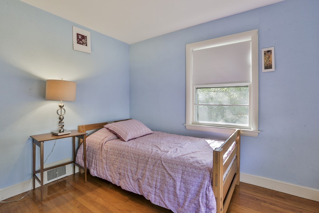 27 Gleason Road Reading, MA 01867 - Photo 9 of 28 a bedroom with a bed and a lamp