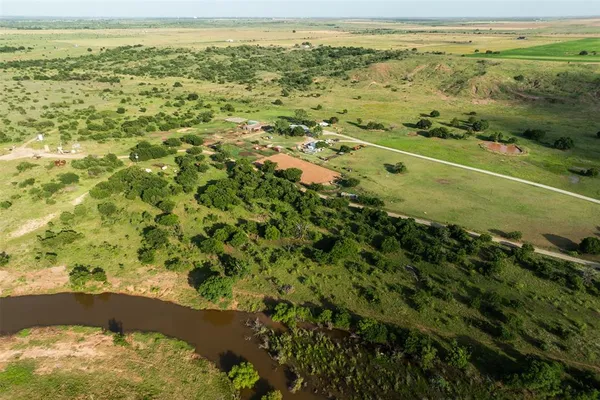 a kitchen with kitchen island a chandelier dining table and chairs
