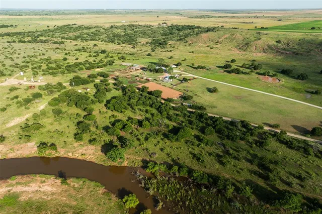 a kitchen with kitchen island a chandelier dining table and chairs