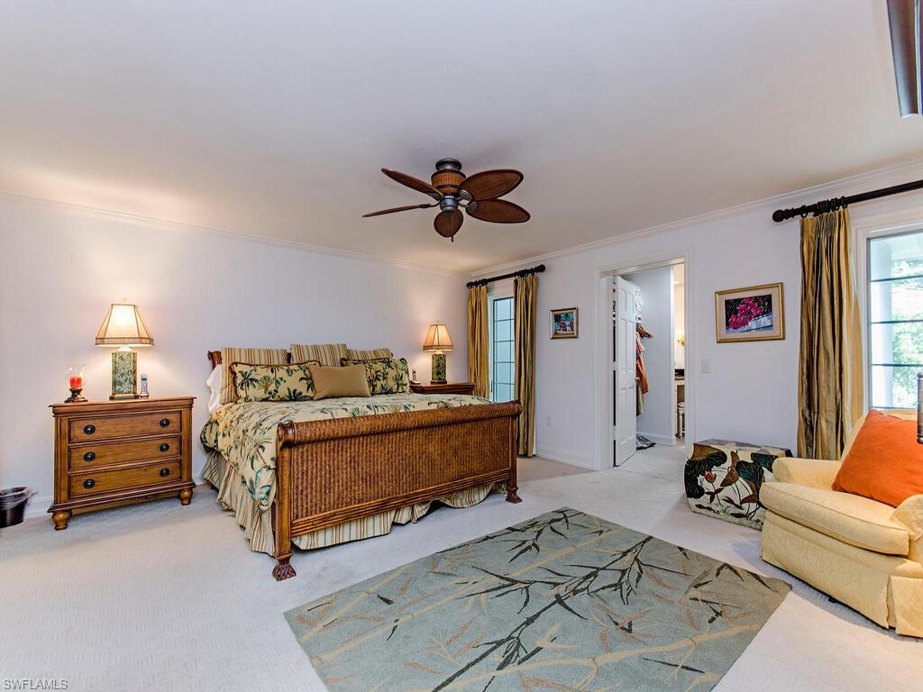 745 Pectin Road Naples, FL 34102 - Photo 14 of 18 a bed room with a bed and a couch