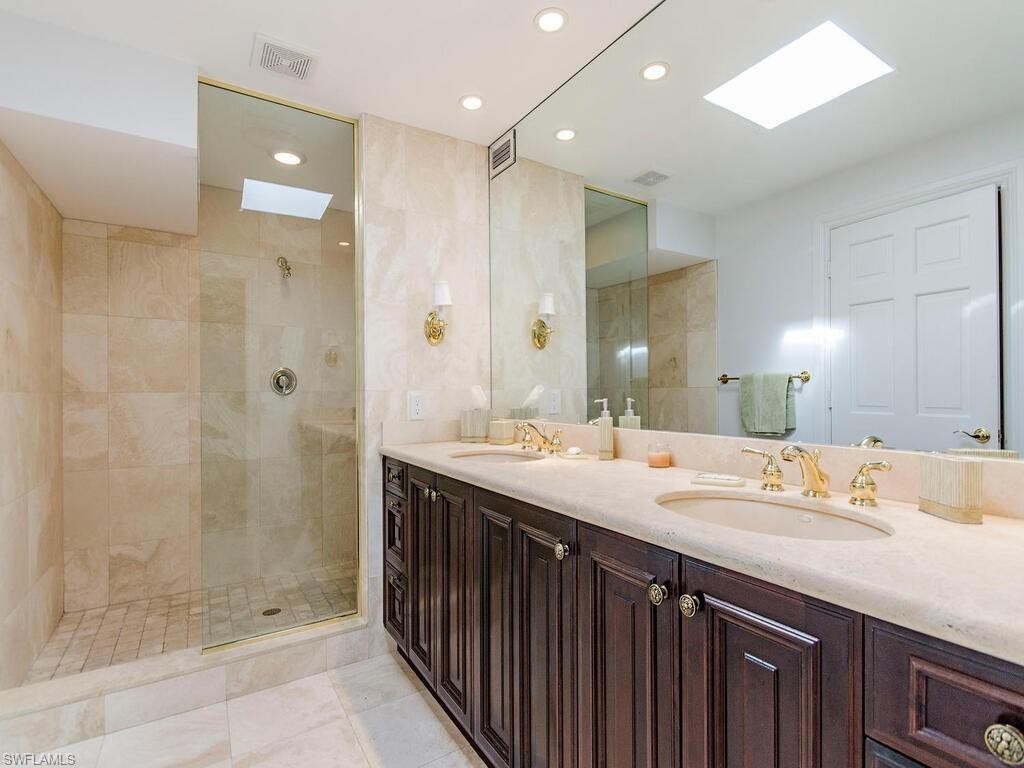 745 Pectin Road Naples, FL 34102 - Photo 15 of 18 a bathroom with a double vanity sink mirror and shower