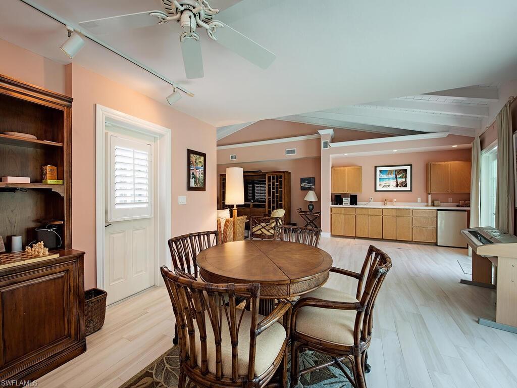 745 Pectin Road Naples, FL 34102 - Photo 18 of 18 a dining room with furniture window and wooden floor