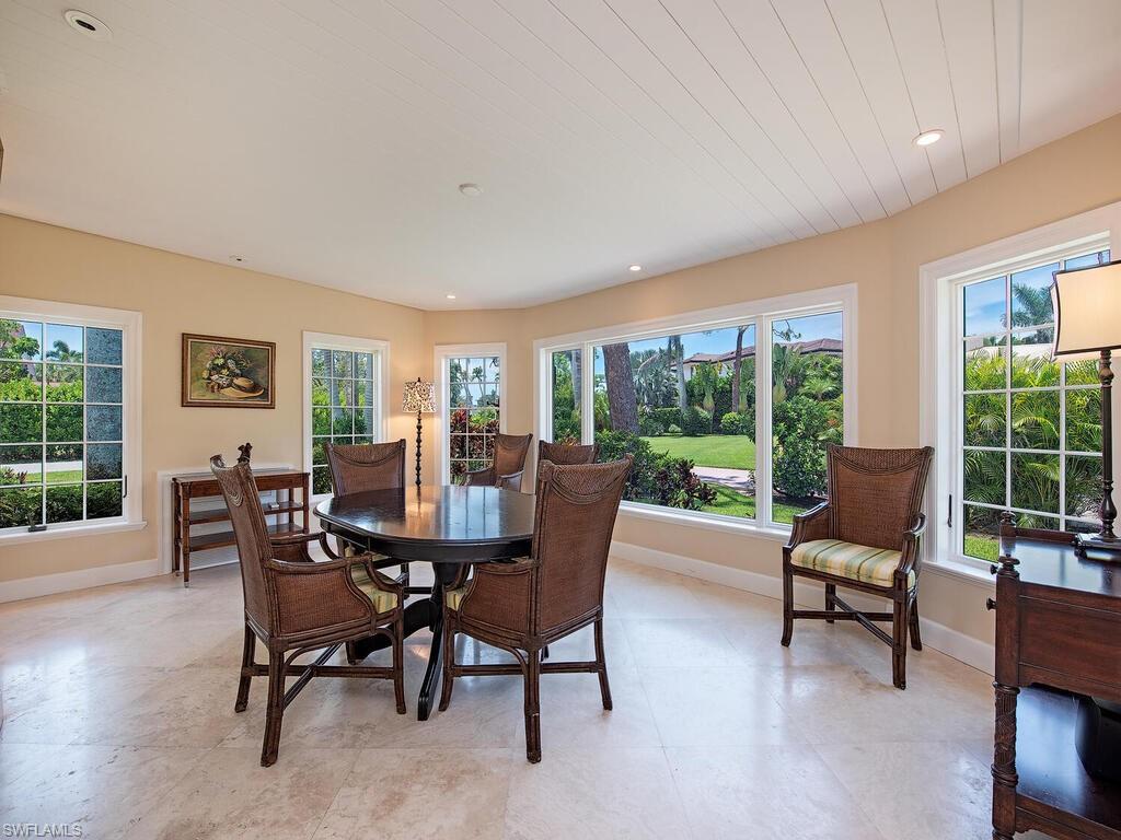745 Pectin Road Naples, FL 34102 - Photo 6 of 18 a dining room with furniture and a floor to ceiling window