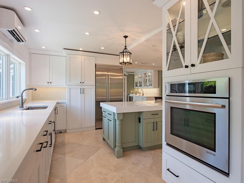 745 Pectin Road Naples, FL 34102 - Photo 8 of 18 a kitchen with a stove and a refrigerator