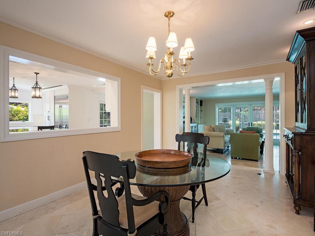 745 Pectin Road Naples, FL 34102 - Photo 10 of 18 a view of a dining room with furniture and a chandelier
