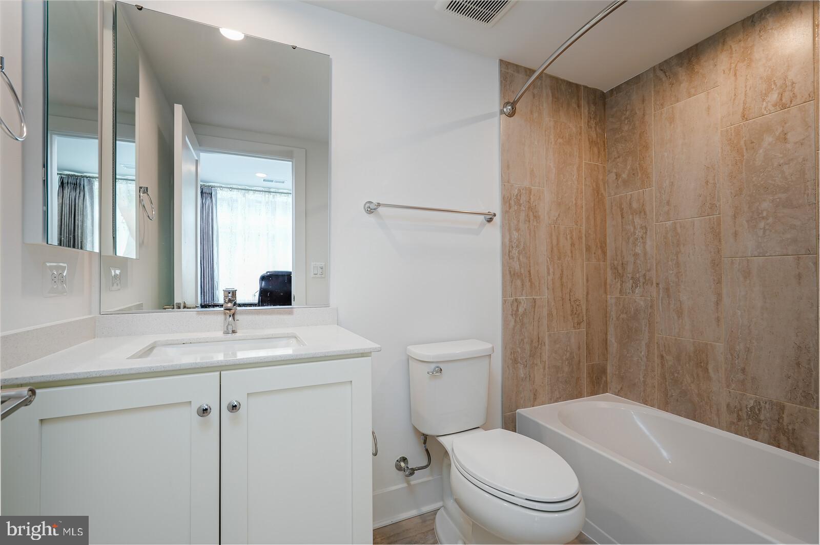 5345 Zenith Overlook Bethesda, MD 20816 - Photo 8 of 53 a bathroom with a sink a toilet a mirror and shower
