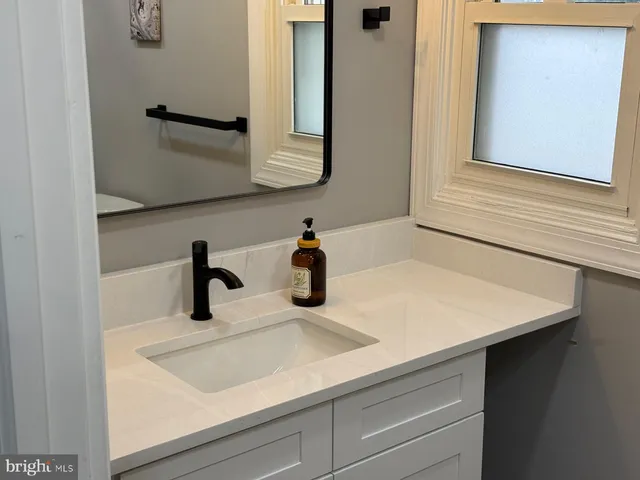 a picture of door and has a painting of a bathroom