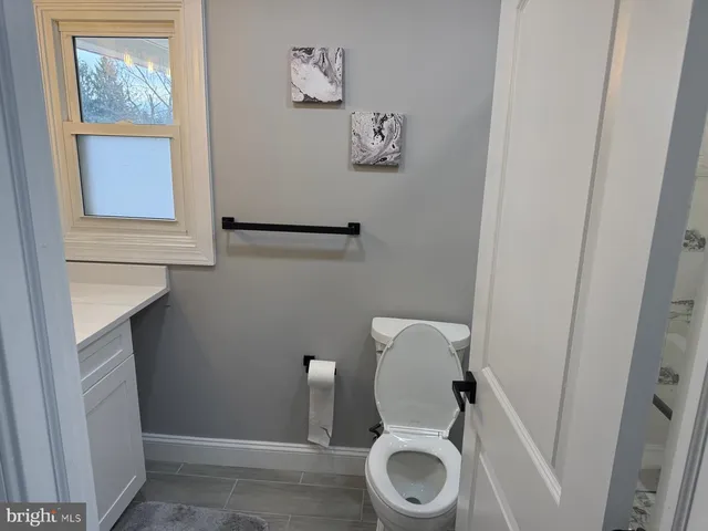 a view of a room with furniture and wooden floor