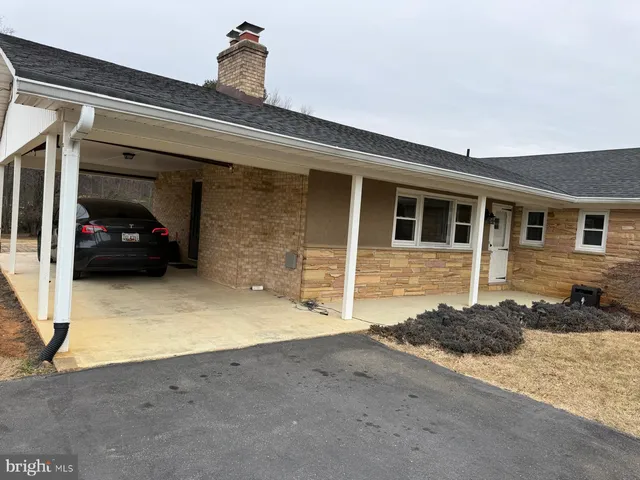 a view of a car parked in front of a house