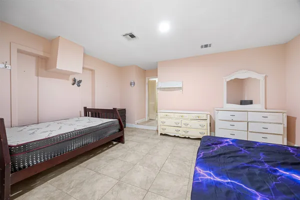 a bedroom with a bed and a dresser